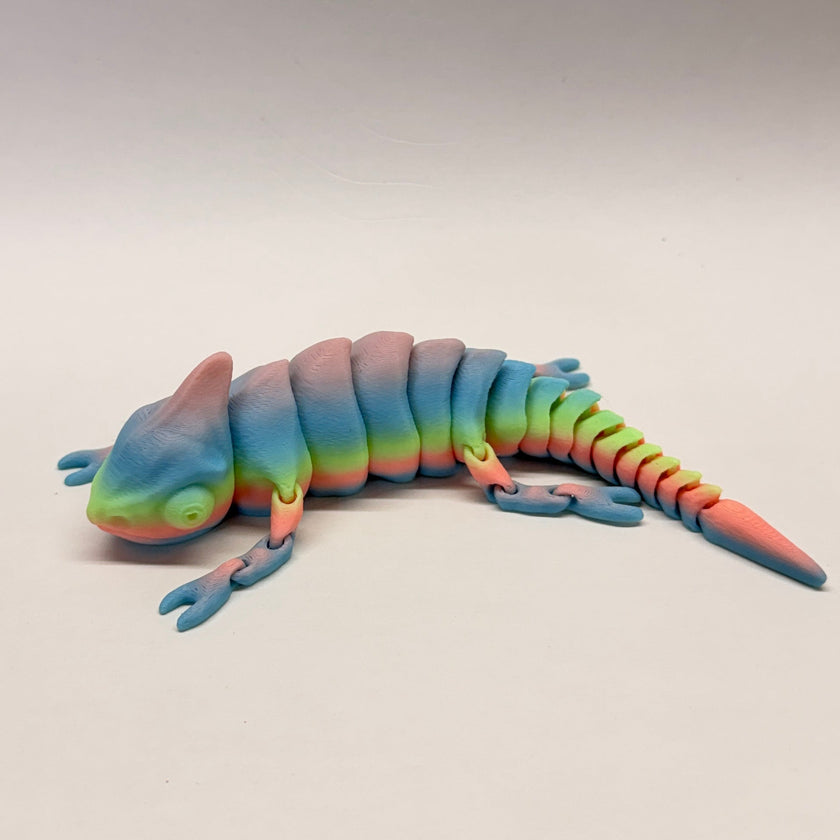 Colorful toy lizard on a plain background