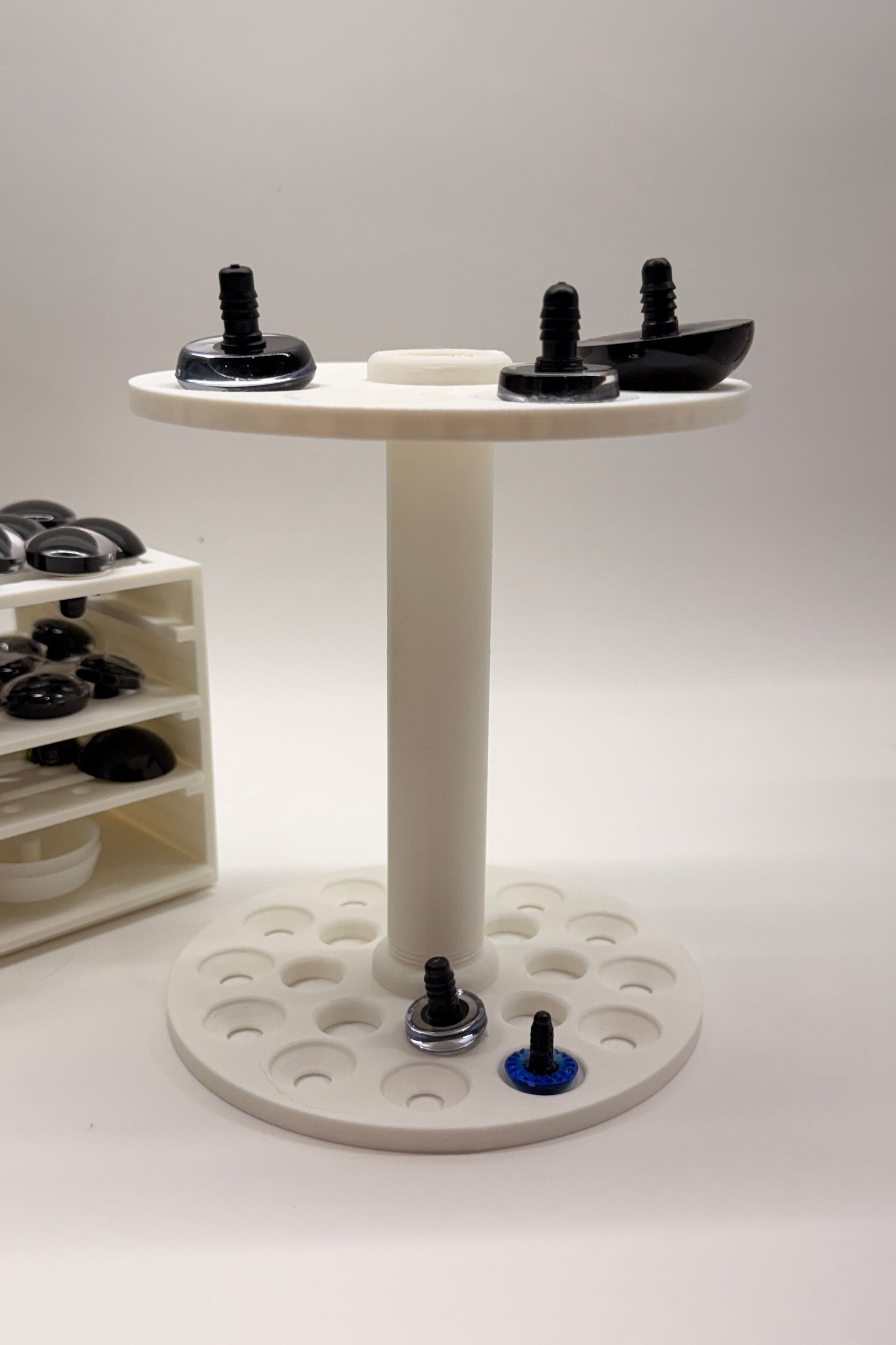 Portable Safety Eye Painter held like an ice cream cone, ergonomic 3D printed craft tool for painting crochet safety eyes anywhere.